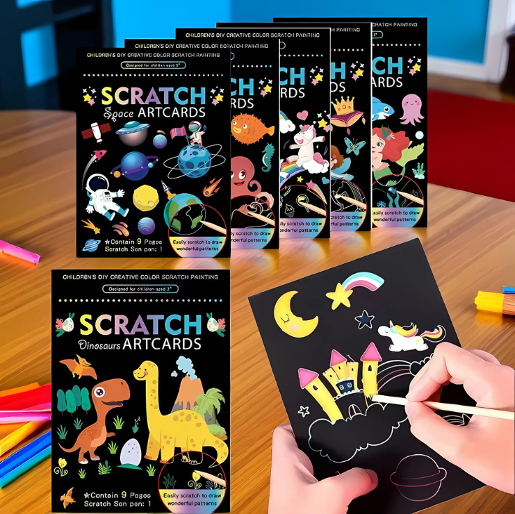 Scratch artcards with colorful designs on a wooden surface